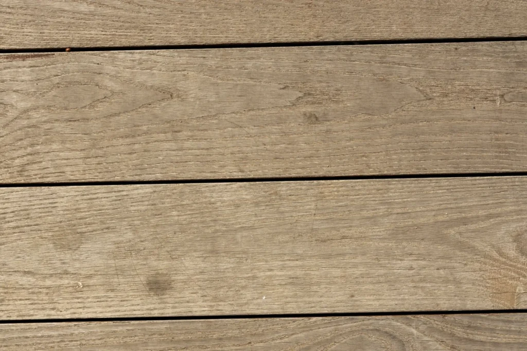 Close-up of a wooden surface with distinct horizontal planks and visible grain patterns.